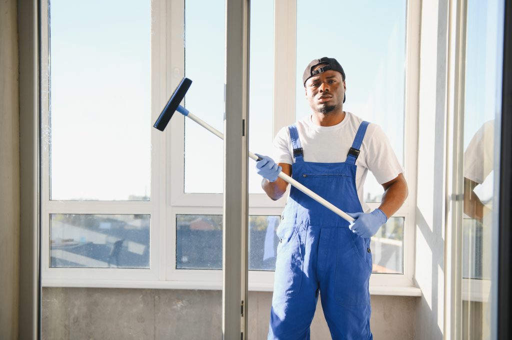 Team using lift to clean exterior office building windows in Dubai